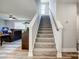 Carpeted staircase leading to upper level; natural light; open floor plan with view into living area at 3018 Corinth Church Rd, Monroe, NC 28112