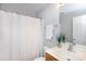 Well-lit bathroom featuring a vanity with sink, toilet, shower with curtain, and a decorative plant at 3138 Golden Dale Ln, Charlotte, NC 28262