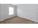 Neutral bedroom featuring a window letting in natural light and soft carpeting at 3138 Golden Dale Ln, Charlotte, NC 28262