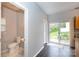 Bright kitchen area featuring a half bath and sliding glass doors to the outside patio at 3138 Golden Dale Ln, Charlotte, NC 28262
