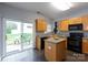 Well-lit kitchen with an island and sliding doors to a patio at 3138 Golden Dale Ln, Charlotte, NC 28262