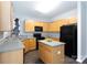 Spacious kitchen with island, black appliances, and wood cabinets at 3138 Golden Dale Ln, Charlotte, NC 28262