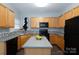 Updated kitchen with light wood cabinetry, an island, and modern appliances at 3138 Golden Dale Ln, Charlotte, NC 28262
