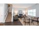 Inviting living room with a staircase, neutral decor, and ample natural light at 3138 Golden Dale Ln, Charlotte, NC 28262