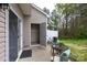 Outdoor patio area featuring table and chairs with sliding glass door to the home's interior and a storage area at 3138 Golden Dale Ln, Charlotte, NC 28262