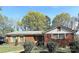 Charming brick home featuring manicured landscaping, shutters, and a welcoming front yard in a serene neighborhood at 3220 Wiseman Dr, Charlotte, NC 28227