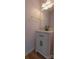 Compact powder room with a white vanity, black hardware, and marble countertop at 3712 Autumn Gold Ct, Charlotte, NC 28278