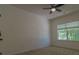 Cozy bedroom featuring plush carpeting, a ceiling fan, and a window with a backyard view at 3712 Autumn Gold Ct, Charlotte, NC 28278
