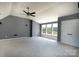 Spacious bedroom with plush carpeting, ceiling fan, and multiple windows at 3712 Autumn Gold Ct, Charlotte, NC 28278