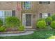 Close up of a classic brick home entrance with manicured shrubs and stylish front door at 3712 Autumn Gold Ct, Charlotte, NC 28278