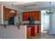 A well-lit kitchen featuring wood cabinetry, stainless steel appliances, and a convenient breakfast bar at 3712 Autumn Gold Ct, Charlotte, NC 28278