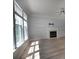 Open living room with wood floors, a fireplace, and ample natural light from large windows at 3712 Autumn Gold Ct, Charlotte, NC 28278