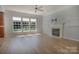 Spacious living room featuring wood floors, a fireplace, and plenty of natural light at 3712 Autumn Gold Ct, Charlotte, NC 28278