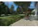 A backyard patio constructed of pavers, and a grass yard with mature trees at 3712 Autumn Gold Ct, Charlotte, NC 28278