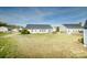 Large backyard with a well-maintained lawn, fence, and mature trees at 4002 Shadow Pines Cir, Indian Trail, NC 28079