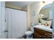 Bathroom features a shower-tub combo with a white curtain, dark wood cabinets, and decor at 4002 Shadow Pines Cir, Indian Trail, NC 28079