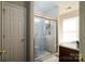 Bathroom featuring a glass shower with marble-look tile, and updated fixtures at 4002 Shadow Pines Cir, Indian Trail, NC 28079