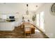 Bright dining area with wood floors, white walls and ceiling, updated lighting, and access to the backyard at 4002 Shadow Pines Cir, Indian Trail, NC 28079