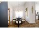 Modern dining room featuring a unique light fixture, large painting, and seating for eight at 4002 Shadow Pines Cir, Indian Trail, NC 28079