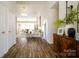 Bright entryway with wood floors, decorative console table and accents, leading into a living area at 4002 Shadow Pines Cir, Indian Trail, NC 28079