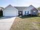 Charming single-story home with a well-manicured lawn, a two-car garage, and stone accents at 4002 Shadow Pines Cir, Indian Trail, NC 28079