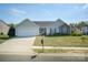 Inviting single-Gathering home featuring a well-kept lawn, a driveway, and a welcoming entrance at 4002 Shadow Pines Cir, Indian Trail, NC 28079