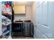 Laundry room with modern washer and dryer, storage shelves and wood-look flooring at 4002 Shadow Pines Cir, Indian Trail, NC 28079