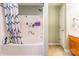 Well-maintained bathroom with a shower/tub combo featuring white tiling, a patterned curtain, and neutral-colored walls at 4058 Canvas Ave, Rock Hill, SC 29732