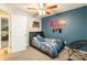 Inviting bedroom featuring a distinctive blue wall, complemented by a ceiling fan and natural light from nearby windows at 4058 Canvas Ave, Rock Hill, SC 29732