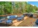 Spacious wooden deck featuring comfortable seating, outdoor grills, and a scenic view of the surrounding greenery at 4058 Canvas Ave, Rock Hill, SC 29732