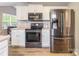Well-equipped kitchen with stainless steel appliances, including a refrigerator, oven, and microwave, all set within white cabinetry at 4058 Canvas Ave, Rock Hill, SC 29732