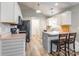 Well-lit kitchen with white cabinets, updated appliances, and a functional island with bar stool seating at 4058 Canvas Ave, Rock Hill, SC 29732