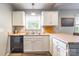 Bright kitchen features white cabinets, stainless steel sink, and neutral countertops, offering a clean and functional space at 4058 Canvas Ave, Rock Hill, SC 29732