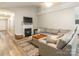 Cozy living room with fireplace, TV, comfortable sectional sofa, and a view into the hallway at 4058 Canvas Ave, Rock Hill, SC 29732