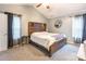 A relaxing main bedroom with a wood-accent headboard, carpeted floor, and light-filled windows at 4058 Canvas Ave, Rock Hill, SC 29732