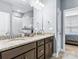 Bathroom with double sinks, granite countertop, modern fixtures, and a view into the bedroom at 4112 Steel Way, Sherrills Ford, NC 28673
