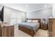 Cozy bedroom with a wooden bed frame, bedside tables and plenty of natural light from the window at 4112 Steel Way, Sherrills Ford, NC 28673