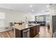 Open-concept kitchen and living area with a granite island, stainless steel appliances, and spacious seating at 4112 Steel Way, Sherrills Ford, NC 28673
