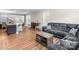 Open-concept living area featuring a comfortable sectional sofa, hardwood floors, and plenty of natural light at 4112 Steel Way, Sherrills Ford, NC 28673