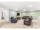 Large upstairs living room with comfortable leather reclining furniture and a wall-mounted TV at 4112 Steel Way, Sherrills Ford, NC 28673