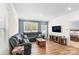 Comfortable living room featuring a sectional sofa, hardwood floors, mounted television, and natural light at 4112 Steel Way, Sherrills Ford, NC 28673