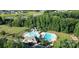 Aerial view of community pools, waterslide and clubhouse surrounded by lush greenery at 4427 Bright Rd, Charlotte, NC 28214