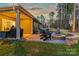 Outdoor patio featuring a fire pit, ample seating, and a built-in grilling station at 4427 Bright Rd, Charlotte, NC 28214