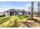 A spacious backyard featuring a stone fire pit and hot tub, perfect for outdoor gatherings and relaxation at 4427 Bright Rd, Charlotte, NC 28214