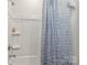 Bathroom with a shower-tub combination with a decorative blue shower curtain and a chrome shower head at 4427 Bright Rd, Charlotte, NC 28214