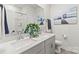 Bathroom features a double sink vanity, wall art, and matching gray cabinetry at 4427 Bright Rd, Charlotte, NC 28214