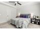 Cozy bedroom with a tray ceiling, plush bedding, soft carpet, and bedside tables with lamps at 4427 Bright Rd, Charlotte, NC 28214