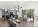 Modern dining area with stylish lighting, a large table, and sliding glass doors leading to the patio at 4427 Bright Rd, Charlotte, NC 28214