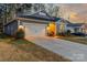 Charming home featuring a two-car garage, manicured lawn, and inviting exterior lighting at 4427 Bright Rd, Charlotte, NC 28214