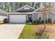 Charming home featuring gray siding, manicured landscaping and a two car garage at 4427 Bright Rd, Charlotte, NC 28214